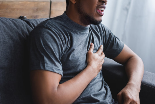 A person pressing a hand to their chest during a moment of panic